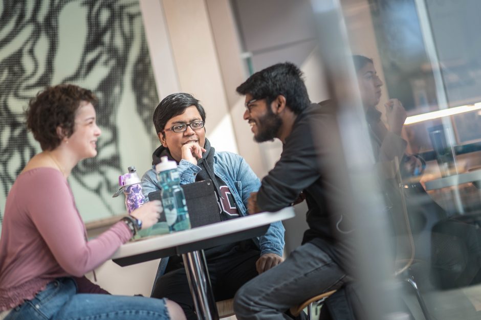 Students discussing at a table